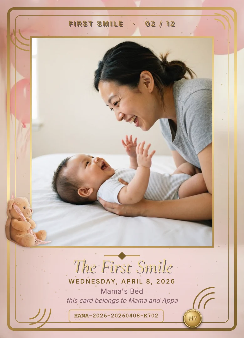 A two-month-old baby grinning up at her laughing mother on a white bed, on a blush pink keepsake card with a teddy bear holding pink balloons sitting on the corner of the photo